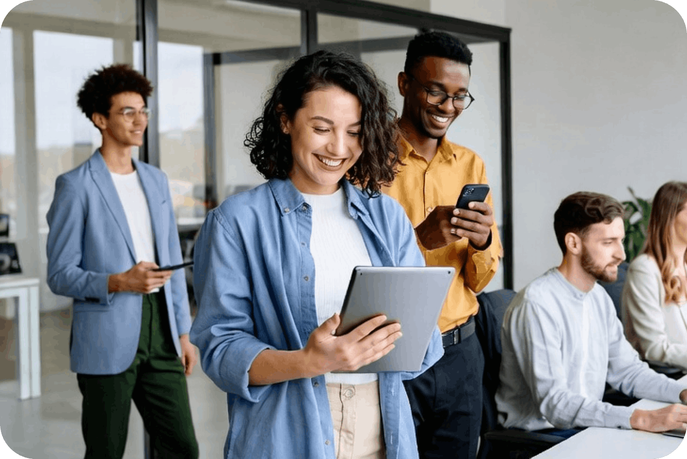 Business team using tablet and smartphones in office environment, representing bulk digital gift card distribution for enterprises and B2B platforms.